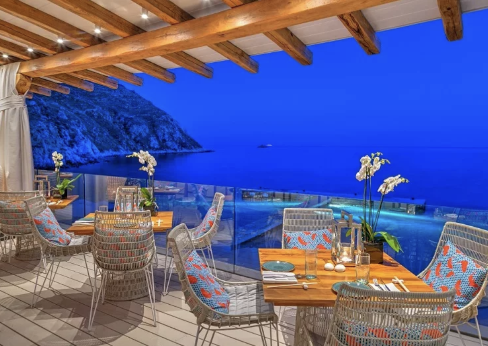 Restaurant overlooking the sea on a Greek island, reinforcing summer, lifestyle, and the atmosphere of Mykonos